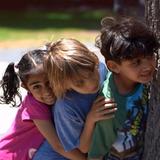 Living Wisdom School Of Palo Alto Photo #9 - Young students play together outdoors, sharing a moment of curiosity and friendship.