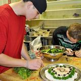 Aseltine School Photo #4 - Culinary Arts students prepare food for a school event they catered. In the program, students learn skills from cooking to safe food handling and preparation to healthy meal planning to budgeting while practicing social skills and learning an in-demand trade.