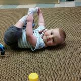 Madison KinderCare Photo #8 - An infant happily playing and exploring his feet in our Infant Classroom.