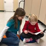 Evergreen Montessori School Photo #7 - Reading buddies takes place once per week. Primary age children are paired with an Elementary student and share their love of reading. This is a great way to foster the relationships while developing compassion, patience and empathy.