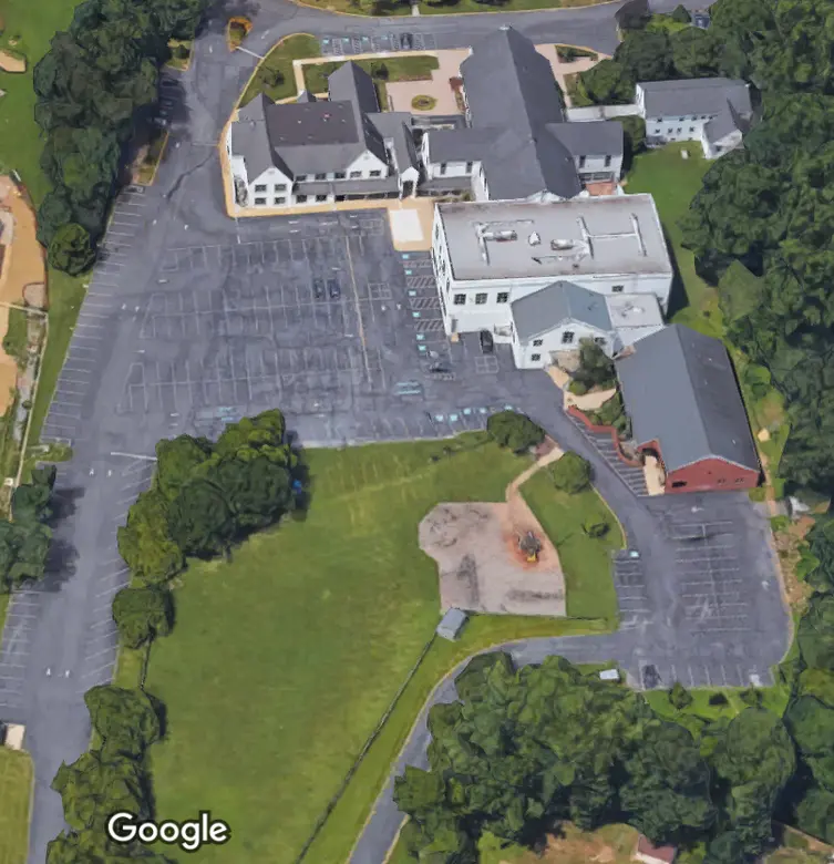 St. John The Baptist School Photo - St. John the Baptist Catholic School is located on New Hampshire Avenue, but the campus is set back against woods, rolling hills, and a field.