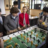 Hillside School Photo #18 - Students playing foosball during recess while enjoying a snack and cheering on their friends.