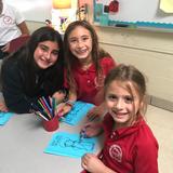 St. Regis Catholic School Photo #2 - Academy students love working with our younger Raiders! We have a strong family of students, teachers, and parents! St. Regis has a House system where our entire school has a sense of camaraderie and family. Starting in Kindergarten, students are sorted in small groups based on a Saint and a Catholic virtue. Students love the activities and learning together!