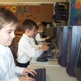 St. Benedict Academy Photo #1 - All students in Kindergarten through sixth grade have and use computers. In addition to our computer lab, all students in third through sixth grade have a laptop for specific and supervised educational use. Technology is meaningfully integrated in every subject at Saint Benedict Academy.
