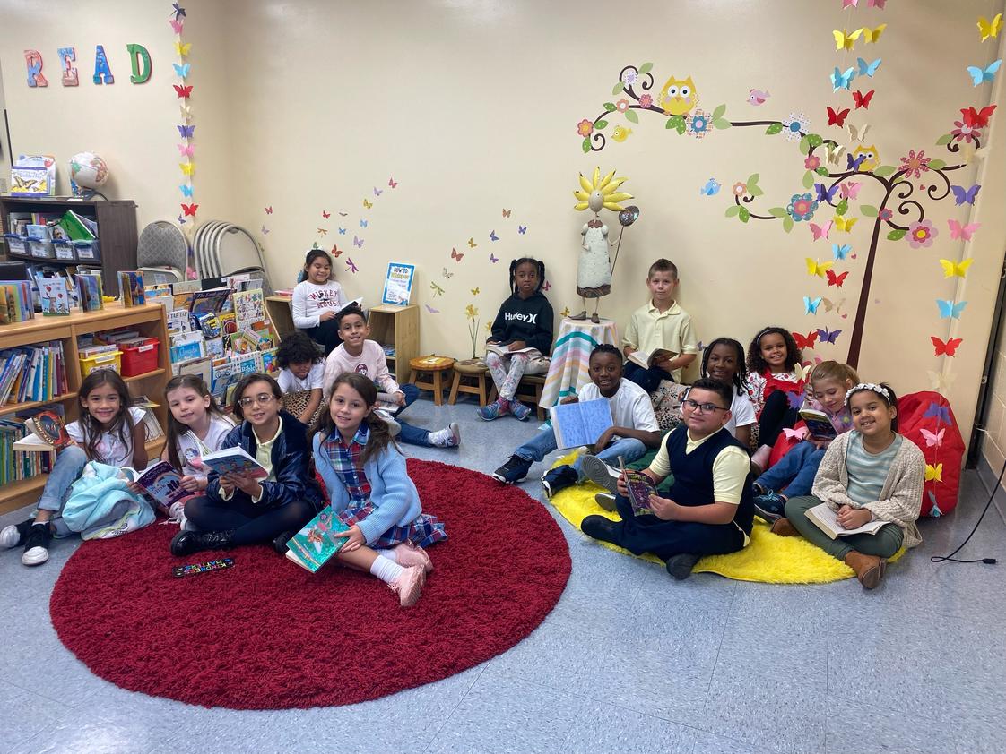 Beacon Christian Academy Photo #1 - Reading in the Butterfly Garden Library section for young children.