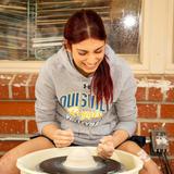 Louisville High School Photo #14 - Ceramics student Sitara P. experiments on the pottery wheel and prepares her piece for the annual Fine Arts Festival.