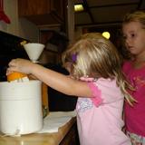 Montessori Child Development Center Photo #3 - Juicing oranges