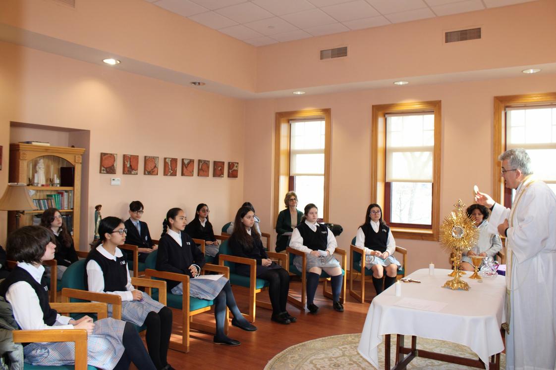 Villa Maria Academy Photo - 2nd-grade students practicing for the Sacrament of Communion with Father Pergjini in the chapel of the convent located right on campus.