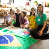 Greensboro Montessori School Photo #5 - Students begin public speaking in our Primary classrooms. This student and her parent (right) gave a presentation about Brazilian culture.