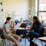 Greensboro Montessori School Photo #14 - A sixth grader enjoys a one-on-one meeting with her Spanish teacher. Our graduates place into Spanish II or III upon entering high school.