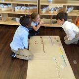 Grand Forks Montessori Academy Photo #4 - Working on math in a collaborative, small group.