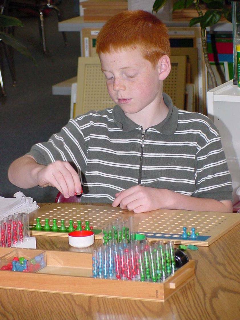 Alexandria Montessori School Photo #1 - Students learn long division using the Montessori material "Test Tube"