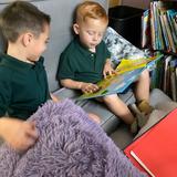 Bishop Flaget School Photo #5 - Kindergarten students relax and enjoy a book during choice time in class.