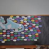 Good Shepherd Christian Academy Photo #3 - Dragon eggs accumulate as students make 100 point test scores. Names of each student appears on each egg and a grand total of 215 means PARTY TIME! Dragon design by Kara Troyer, Senior.