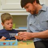 Gladwyne Montessori Photo #2 - Primary teacher giving a lesson to 2 year old student in preparation for his transition into a 3-6 year old classroom.