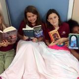Charleston Christian School Photo #8 - Reading can take you on many adventures as these students are learning. They are enjoying the books they checked out from the school library.