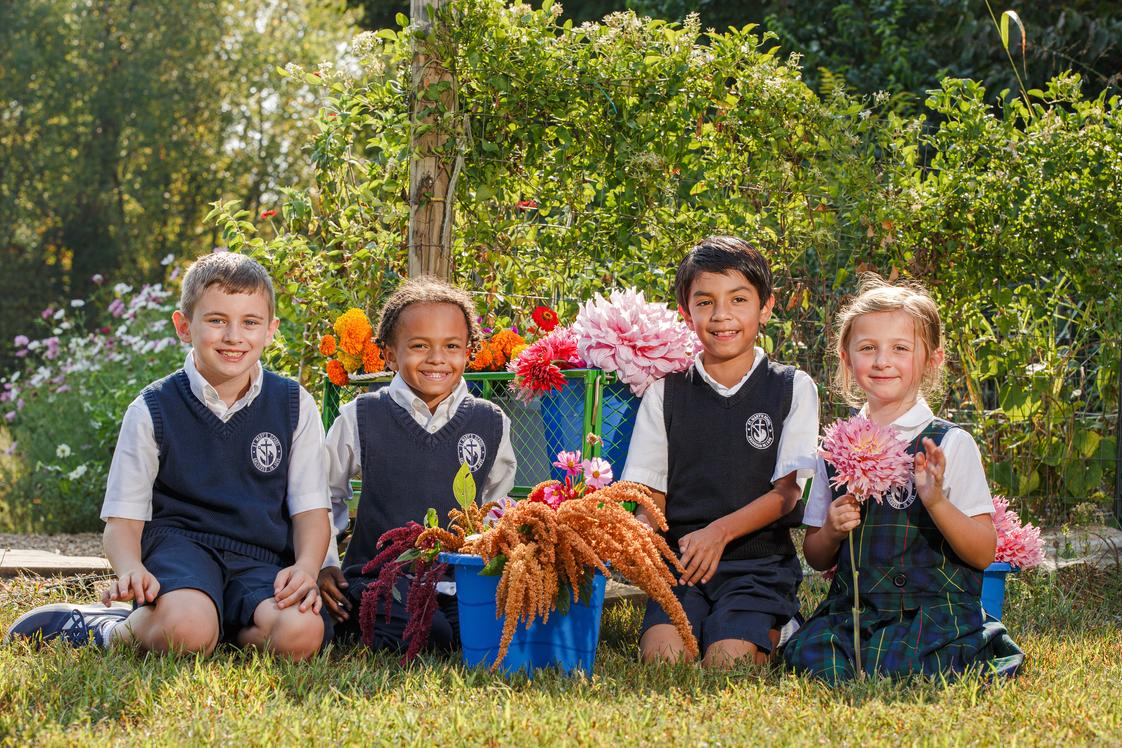 St. Mary School Photo #1 - Our school flower garden allows us to get outside occasionally, soak in some sunshine, and get our hands dirty!
