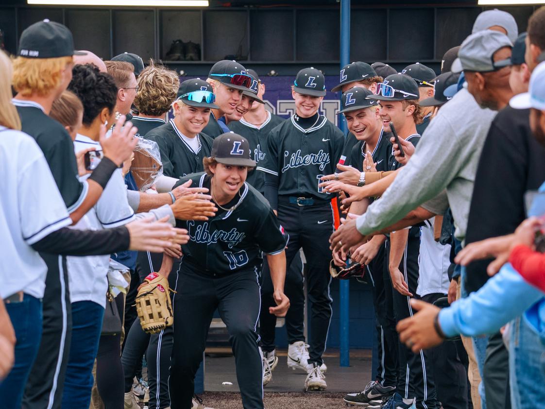 Liberty Christian School Photo - Upper School baseball players celebrate on Senior Night with player introductions while surrounded by members of their family. What a special night!