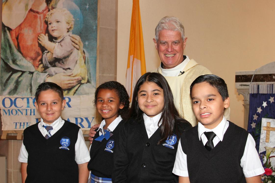 Assumption Catholic School Photo #1 - Fr. Albert, our Parish Pastor, with children after our weekly School Mass