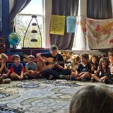 The Circle School Photo #2 - Every school day starts with morning circle. Every child, from Pre-K 3 through 8th grade, participates. Through oral stories passed down from many generations, students are able to learn about different regions and cultures throughout our world and how their experiences from the past impact us today.