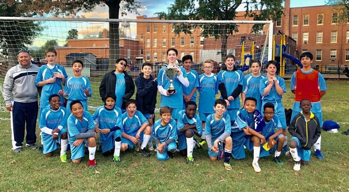 St. Thomas Aquinas Regional School Photo - Aquinas boys' soccer team celebrating their championship win.