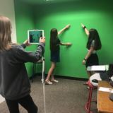 Norfolk Collegiate School Photo - Middle school students use the green room to film a short video for class. The room is equipped with movie editing software, iPads and more for students to utilize.