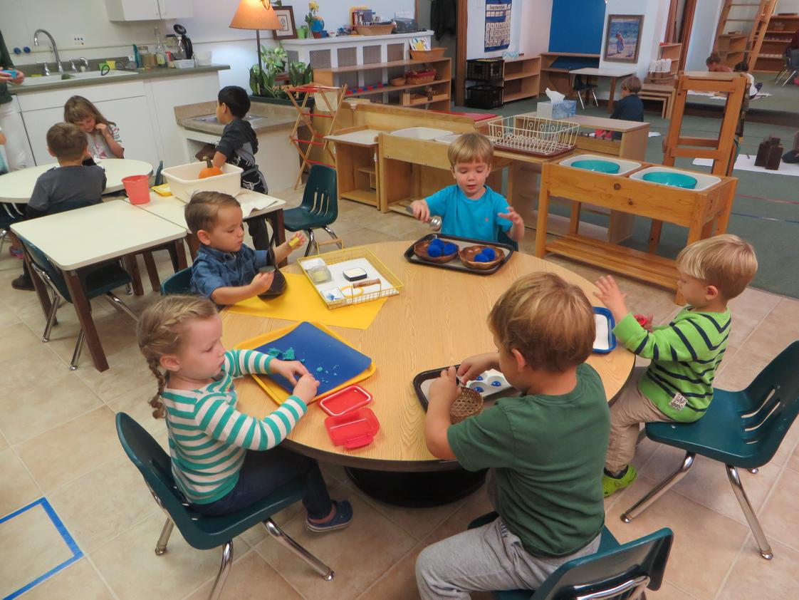 Montessori Children's House Photo - Children chose individual work in Practical Life area. These activities help build concentration, attention to detail and helps develop small muscle control which are all preparation for math, reading and writing.