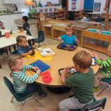 Montessori Children's House Photo - Children chose individual work in Practical Life area. These activities help build concentration, attention to detail and helps develop small muscle control which are all preparation for math, reading and writing.