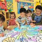 OC Kids Infant & Preschool Photo - Art, Science, Language Arts, Literacy, and Math even our youngest students are working hard at OC Kids Infant and Preschool. Here you can see Ms Diana working with our toddlers on a fun cooperative art project.