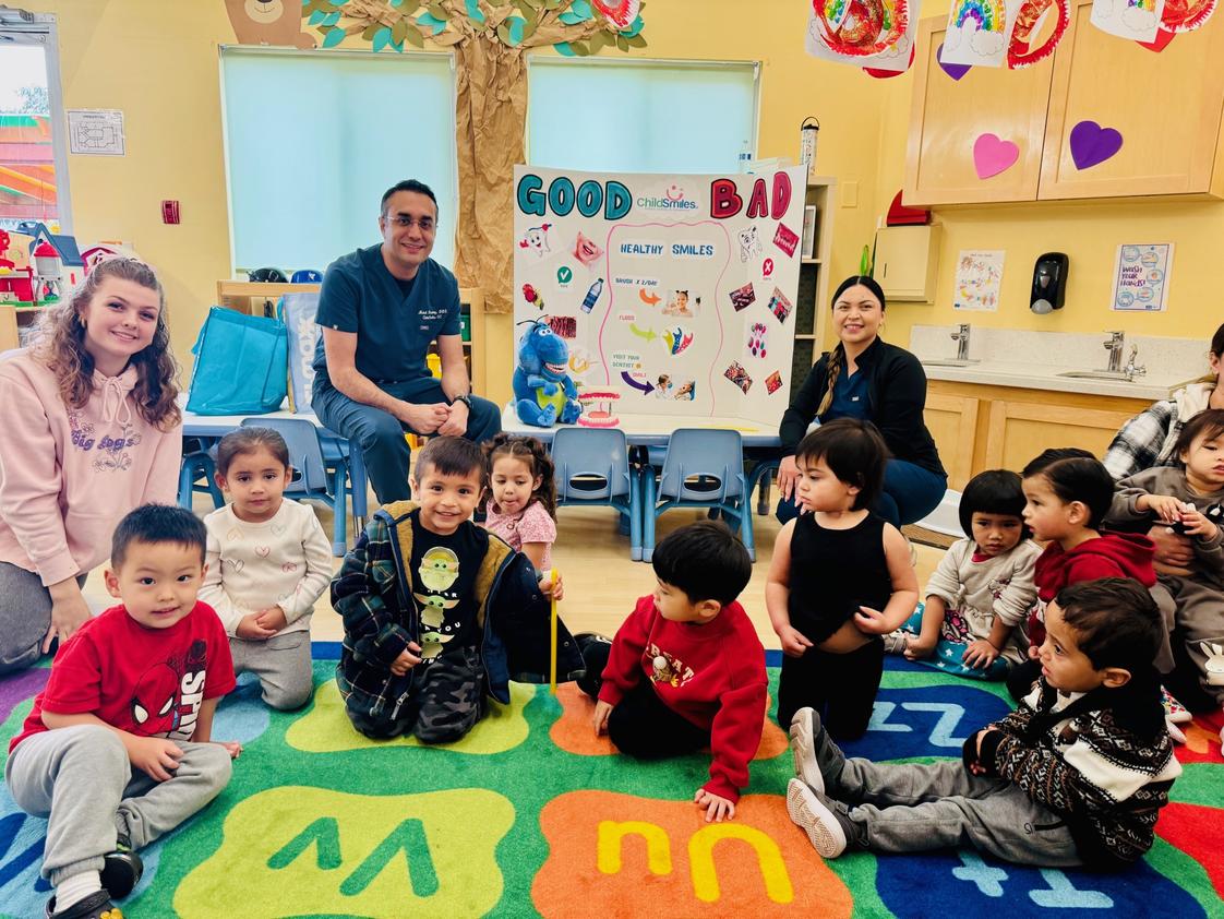 OC Kids Infant & Preschool Photo #1 - We offer a thematic curriculum with weekly topics that engage and encourage our children to ask questions and stay curious about the lessons. Here you can see a visit from our local dentist during Healthy Habits week where we learn all about health eating. exercise, dental health and more.