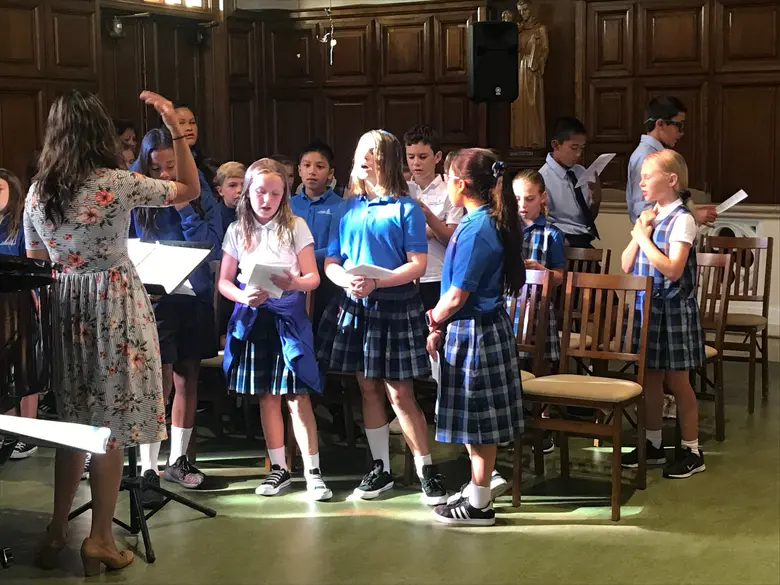 Our Lady Of Mt Carmel School Photo #2 - School choir performing at the monthly all school mass in Our Lady of Mount Carmel Church (across the playground from the school building).