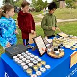 Quest Montessori School Photo #7 - Middle School students proudly sold products from their microbusiness, Narrow River Naturals, at a local fall festival. Experiences like this build confidence, responsibility, and real-world skills, all essential to the Montessori adolescent journey.