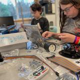 West Sound Academy Photo #9 - Two middle school students in Technology Club work on assembling their robots