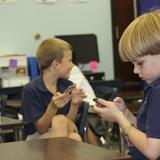 Christ Covenant School Photo #1 - Lower School students use iPod Touches to play interactive learning games in specific subjects.