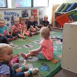 Eden Prairie KinderCare Aztec Photo #4 - Miss Kacie reading to the children during a morning group time.