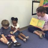 Hampton KinderCare Photo - We love books! Ms. Kathie reads to Skylar and Charlie, while boosting their literacy skills.