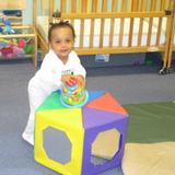 St. Charles KinderCare Photo - Learning to stand and balance in the infant classroom.