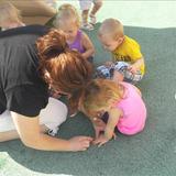 New Lenox KinderCare Photo #6 - Toddlers are doing hand and foot tracing on the playground.