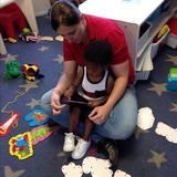 Washington Township KinderCare Photo #9 - Toddler-B students working with Ms. Lori on lacing boards.