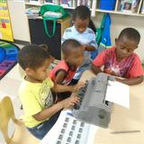 Fairview KinderCare Photo #7 - Children practicing typing braille. Writing their names and trying to make sentences