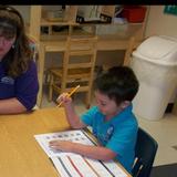 Oak Forest KinderCare Photo #6 - Ms. Anita gets her children ready for Kindergarten by working on their writing skills.