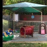 Leesville KinderCare Photo #4 - Our Toddler playground offers grassy areas to allow sensory and nature exploration. It also offers a padded and covered area with slides and tunnels to promote gross motor and social skills. A variety of pushing toys allows children who are beginning to walk or are just starting to walk to build strong muscles!