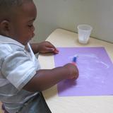 Lexington Knowledge Beginnings Photo #7 - A Toddler Classroom student works with glue.
