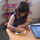 Lone Oak Montessori School Photo #2 - Students trace and color with precision to develop skills they will use to write.