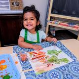The Westwood School Photo #4 - A Toddler student painting with watercolors