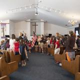 Grace Preparatory School Photo #3 - Every Tuesday morning our elementary students meet in the sanctuary for the pledge of allegiance, bible story and prayer. It's a great way to start the week!