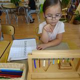 Montessori American School Photo #5 - Montessori students use hands-on learning materials that make abstract concepts clear and concrete. They can literally see and explore what is going on. After much practice, the child attains a meaningful knowledge of concrete numbers.