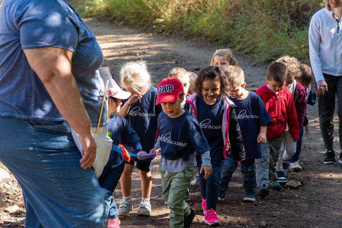 Arches Academy Photo - The Head of School hike is a beloved tradition from the first weeks of school! The whole school gathers to hike up beautiful Big Springs canyon and eat lunch together, play games, and get to know each other and their teachers! The preschool class pictured here loved their adventure on the trail and especially their treat--cookies!