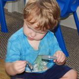 Live Oak Montessori School Photo #5 - A 2-year old is examining snake skin