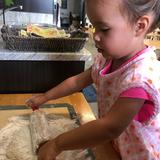 Indiana Montessori Academy Photo #5 - An IMA toddler student rolls the dough for her bread.